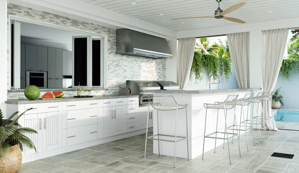 Outdoor kitchen in Southwest Florida with stainless steel appliances, stone countertops, and a pergola